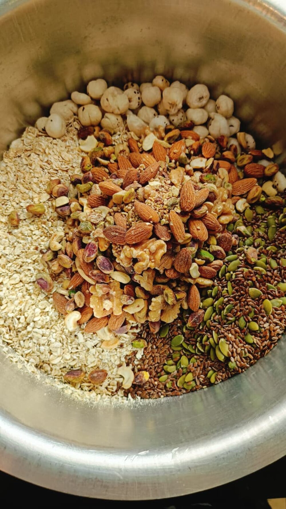 Raw oats, nuts and seeds for our protein powder, laid out before grinding